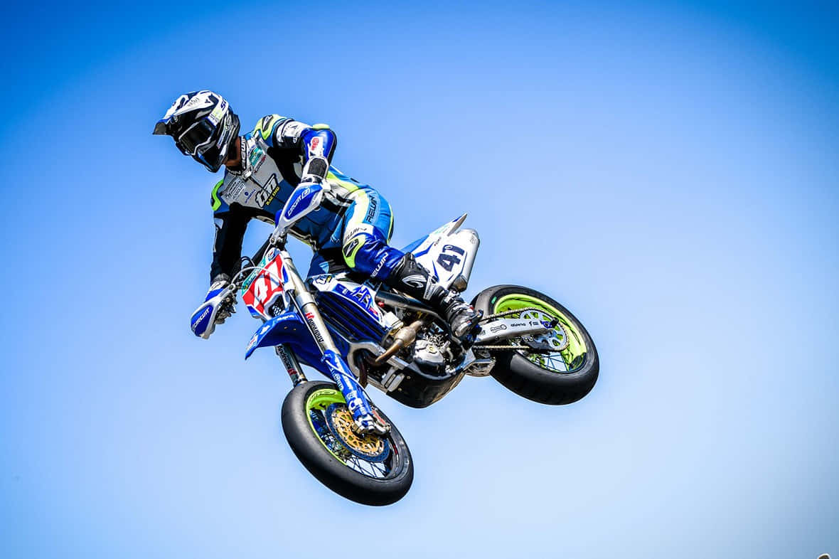 T M Racing Motocross Jump Sky Background Wallpaper