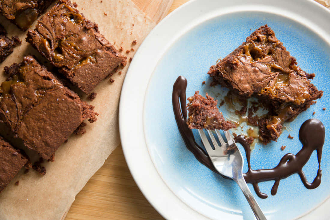 Tasty Caramel Brownie Topped With Chocolate Drizzle Wallpaper