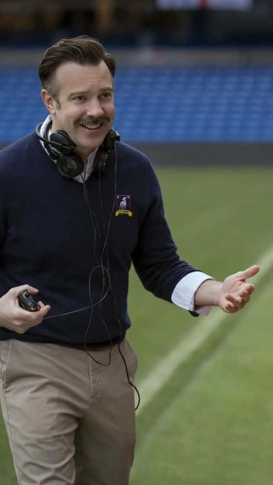 Ted Lasso Headphones Smile Stadium Wallpaper