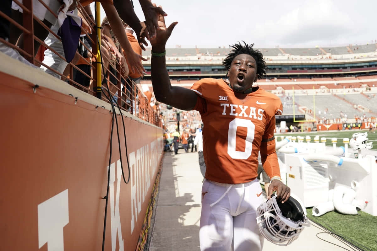 Texas Football Player High Fiving Fans Wallpaper