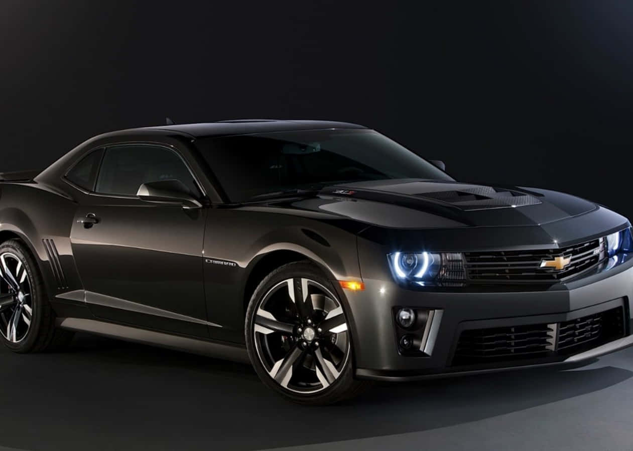 The 2013 Chevrolet Camaro Is Shown In A Dark Background Wallpaper