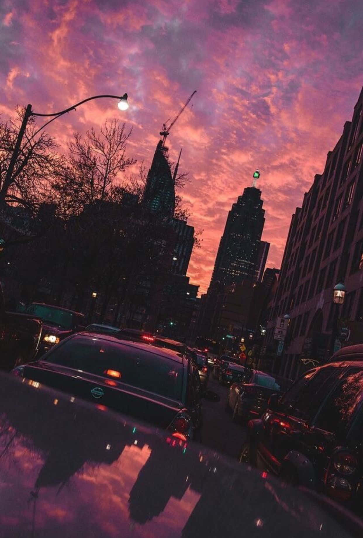 The Beauty Of A Sunset Skyline With A Rose Gold Iphone Capturing The Moment. Wallpaper