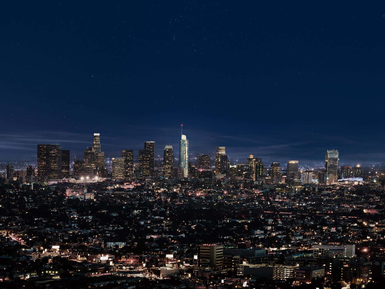 The Enchanting Los Angeles Skyline Embossed By A Star-studded Sky. Wallpaper