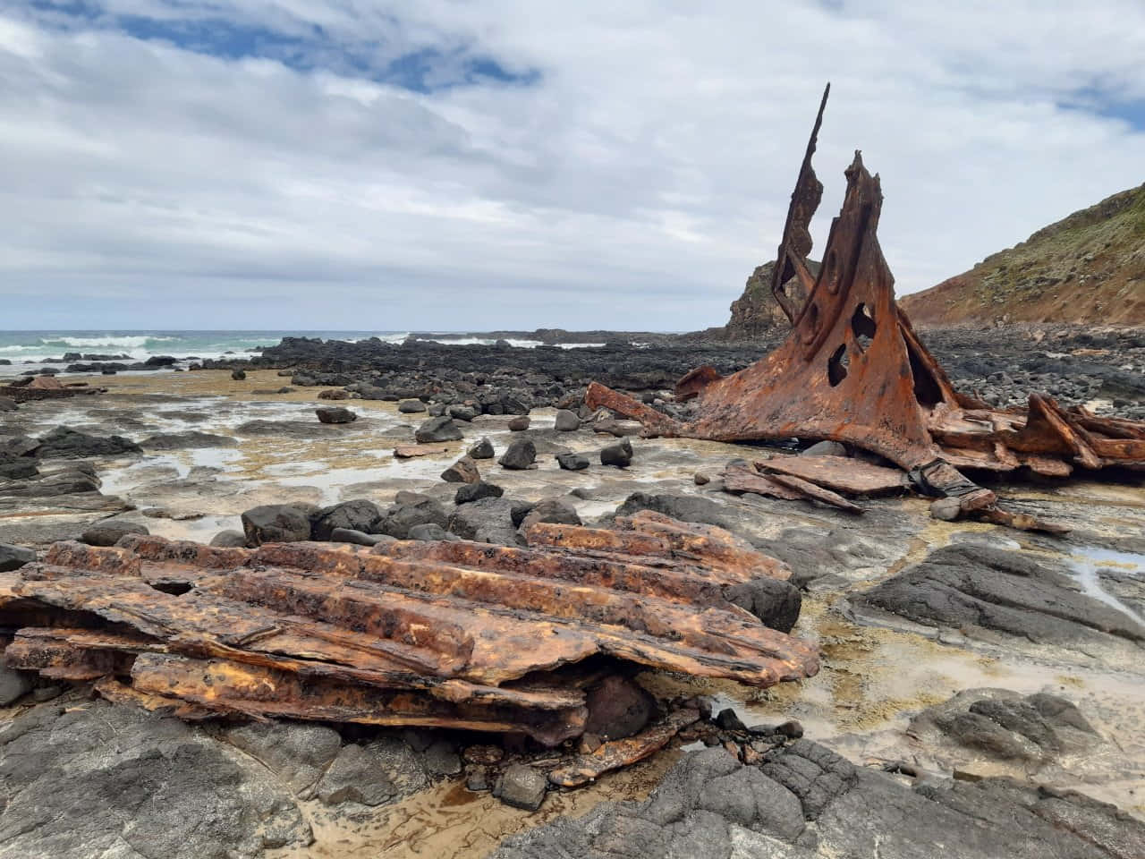 The Final Resting Place: A Majestic Shipwreck Wallpaper