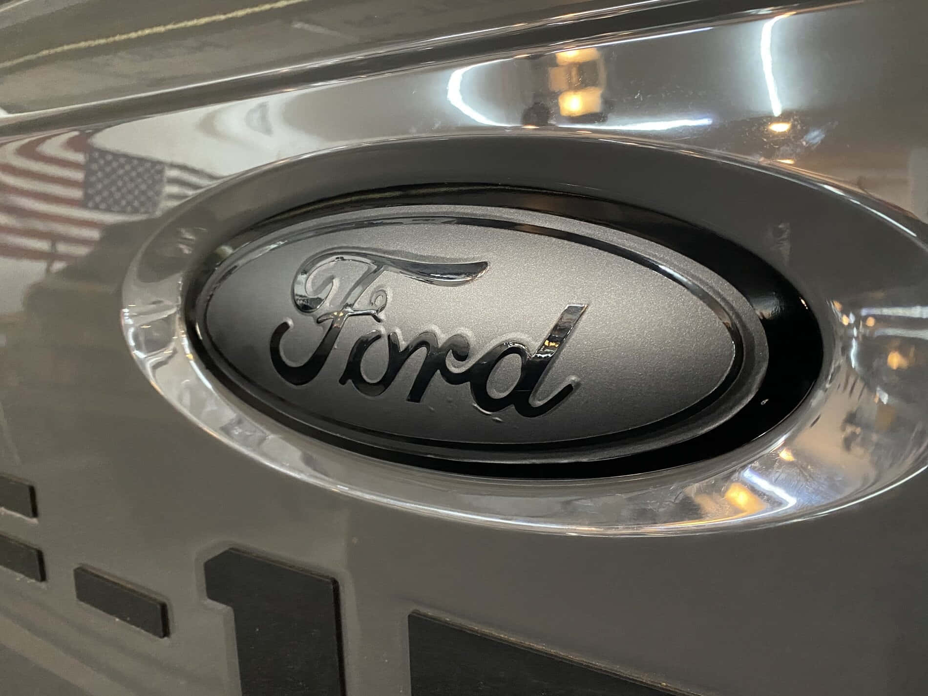 The Iconic Ford Logo On A Dark Background Wallpaper