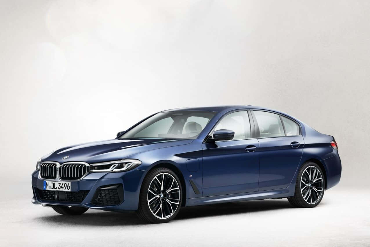 The New Bmw 5 Series Sedan Is Shown In Blue Wallpaper