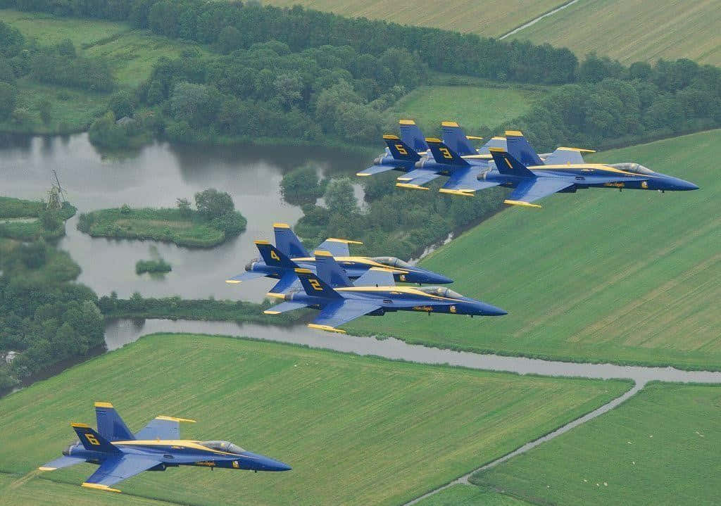 The U.s. Navy Blue Angels Soar In Perfect Formation Wallpaper