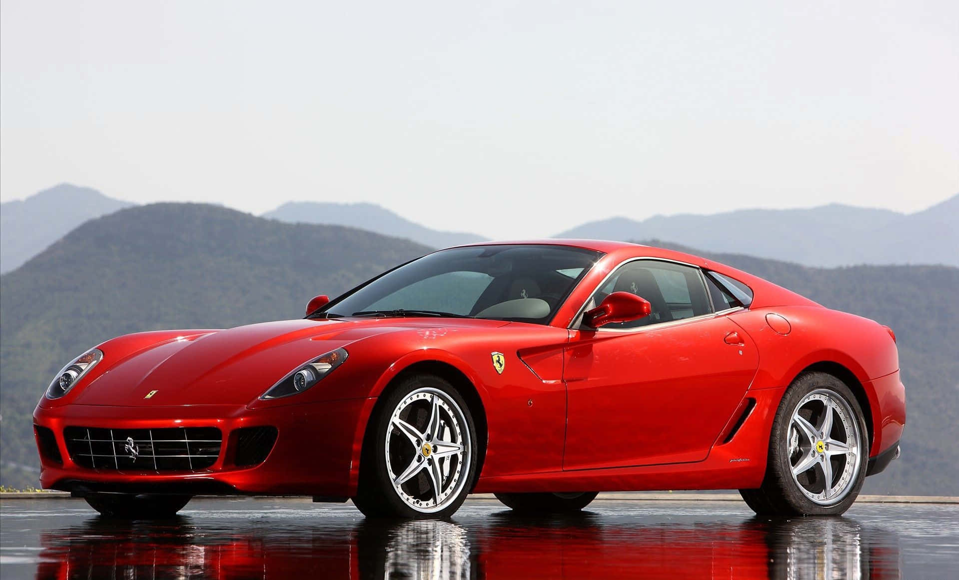 The Vibrant Red Ferrari 599 Gtb Fiorano Showcasing Its Sleek Design And Sporty Elegance Wallpaper