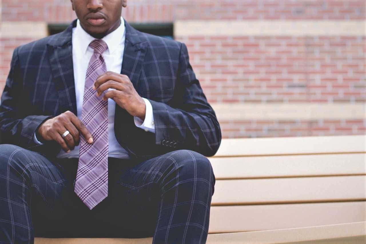 This Dapper Man Is Dressed To The Nines In Purple Tie! Wallpaper