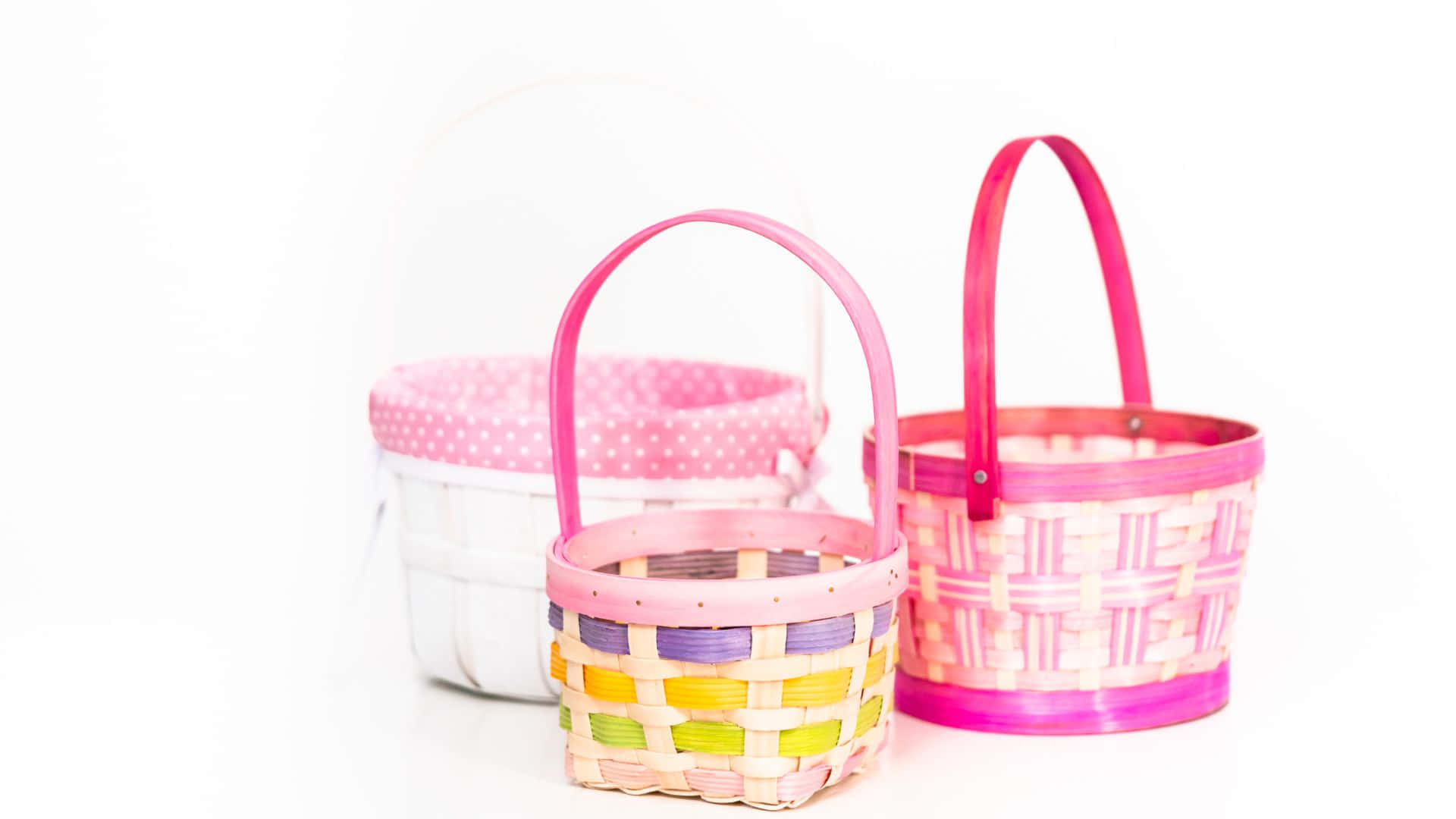 Three Baskets With Handles On A White Surface Wallpaper