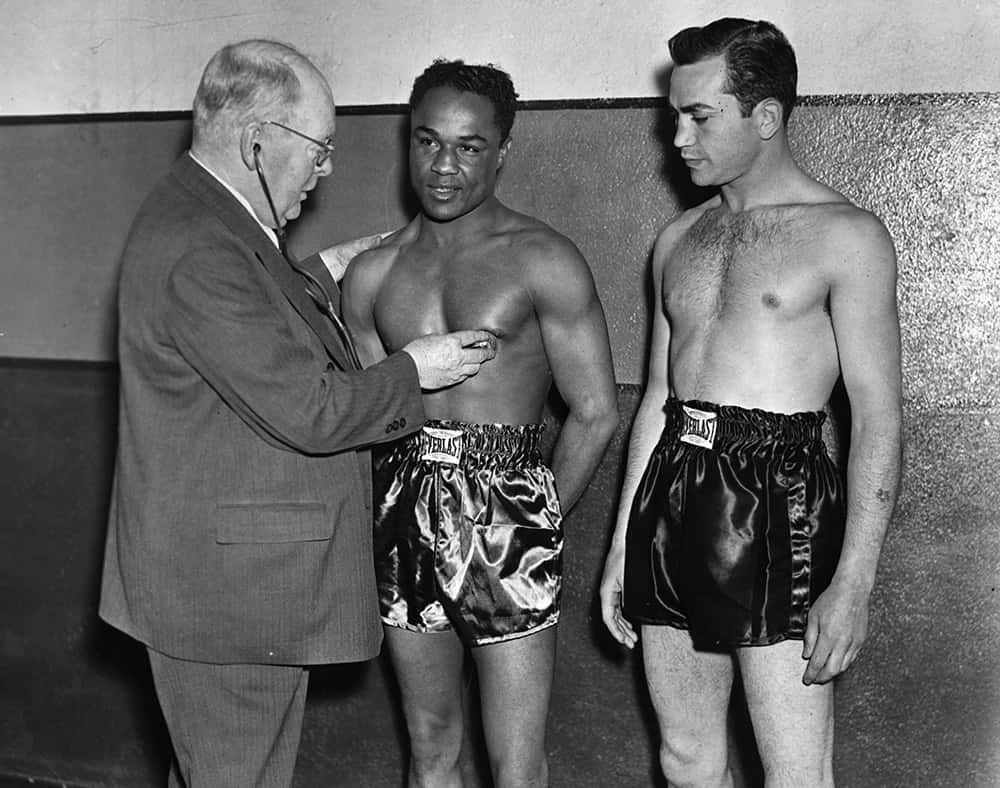 Three Men In Boxing Shorts Standing Next To Each Other Wallpaper