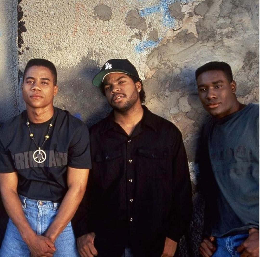 Three Young Men Standing Next To A Wall Wallpaper