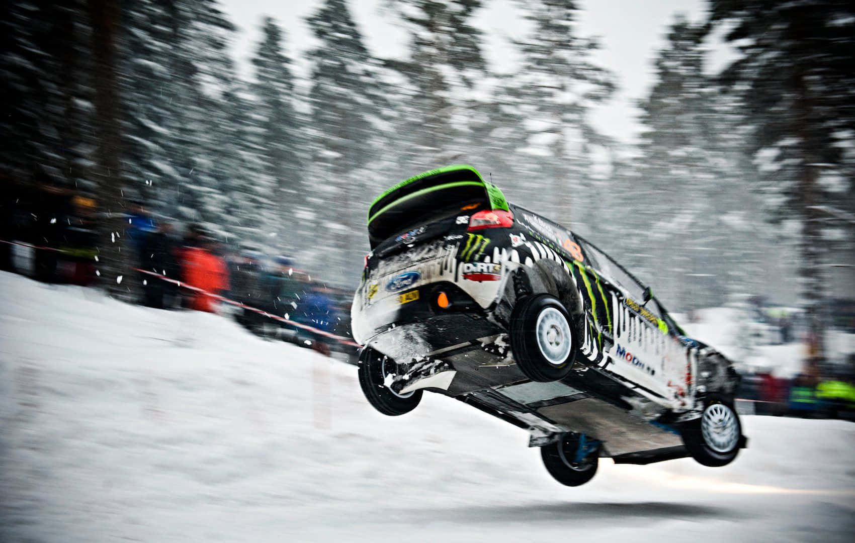 Thrilling Ice Racing Action On A Snow-covered Track Wallpaper