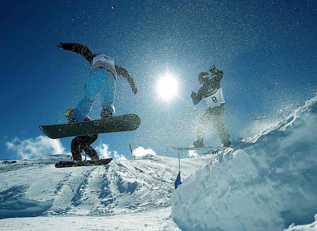 Thrilling Winter Sports Action On A Snowy Day. Wallpaper