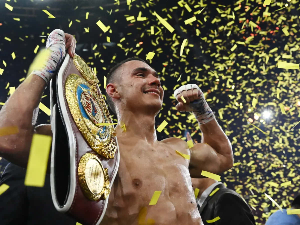 Tim Tszyu Delivering A Powerful Punch During A Boxing Match Wallpaper