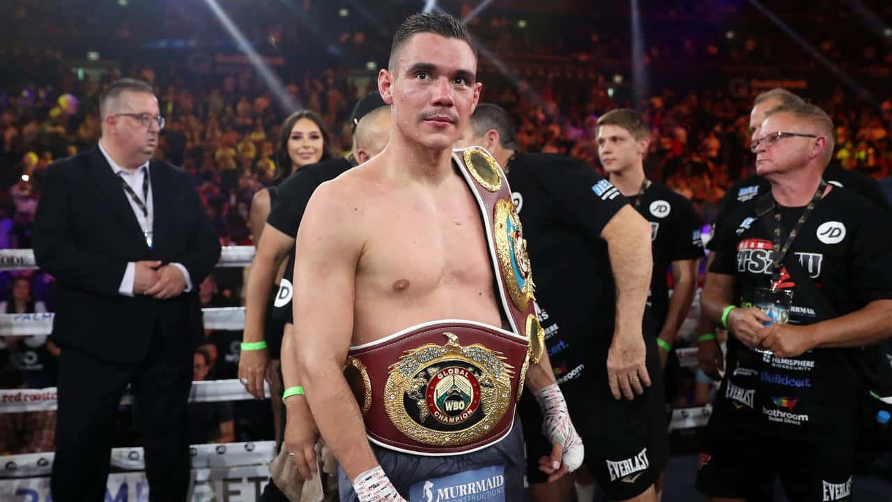 Tim Tszyu Preparing For A Powerful Punch In The Boxing Ring Wallpaper