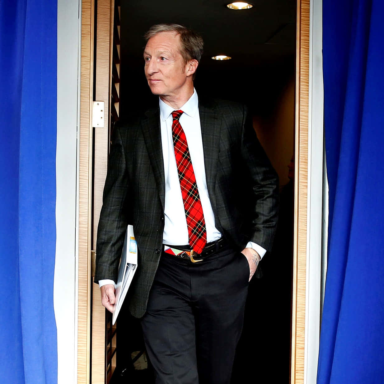 Tom Steyer Standing Against The Door Wallpaper