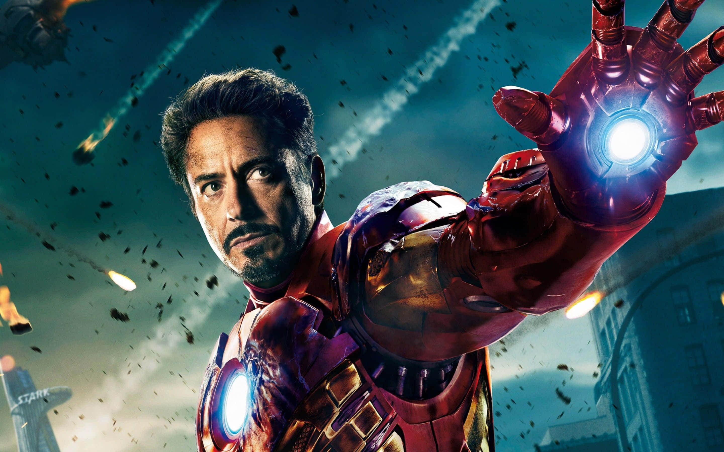 Tony Stark Suiting Up As Iron Man In The Movies Wallpaper