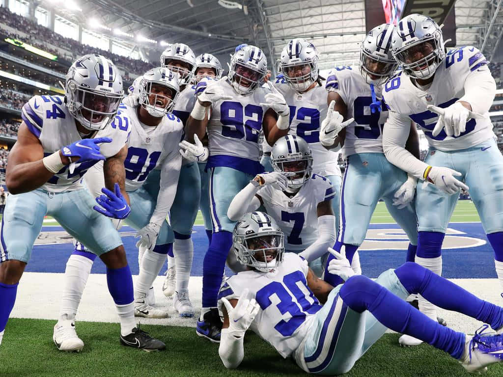 Top Dallas Cowboys Players Celebrating A Touchdown Wallpaper