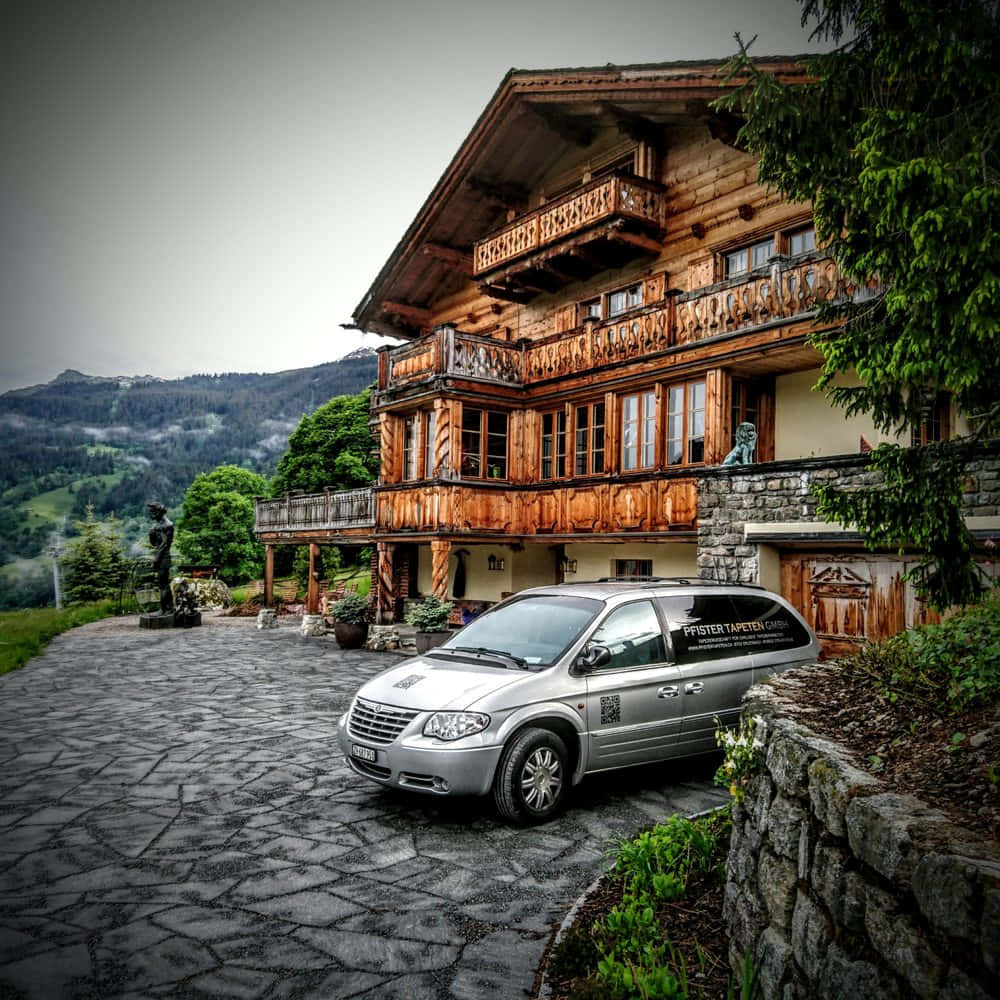 Traditional Swiss Chalet With Vehicle Wallpaper