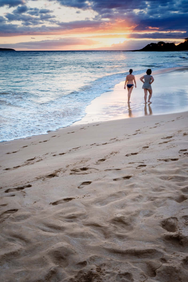 Tranquil Beach Walk At Sunset Wallpaper