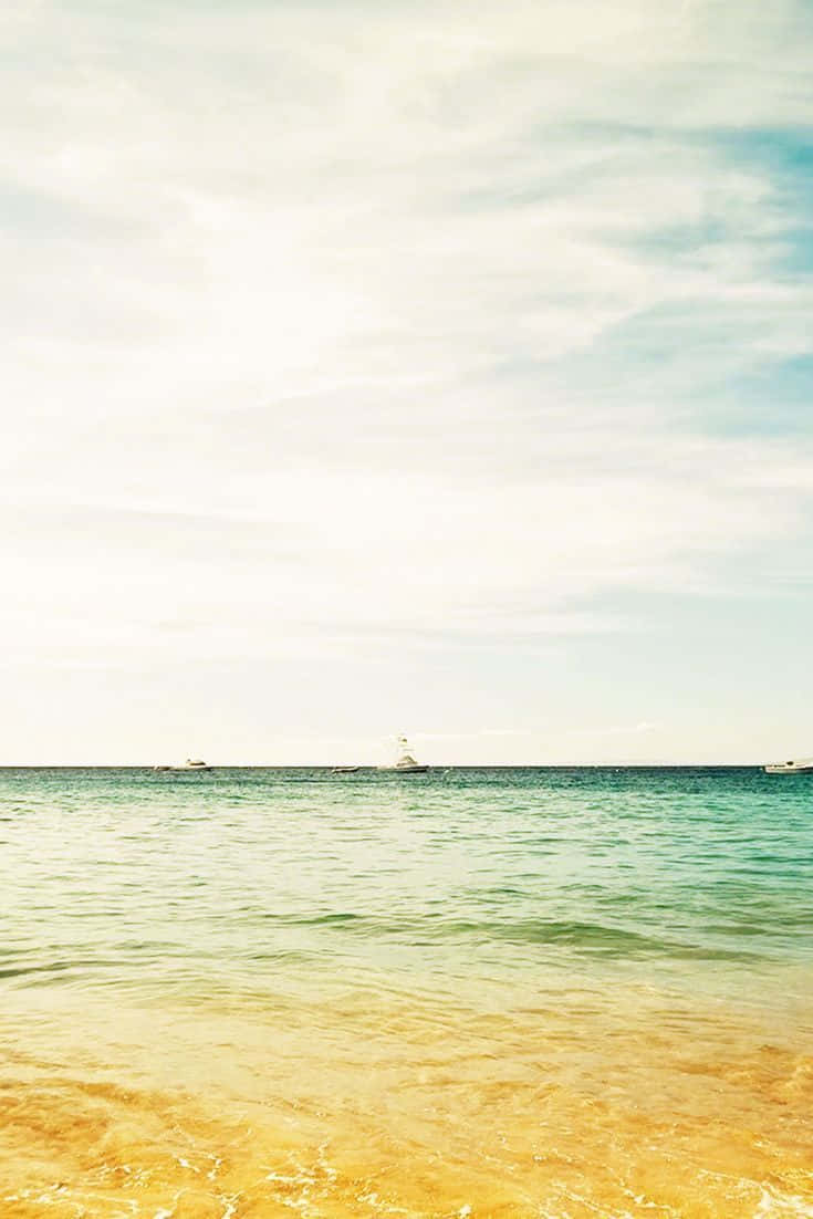 Tranquil Yellow Beach At Sunset Wallpaper