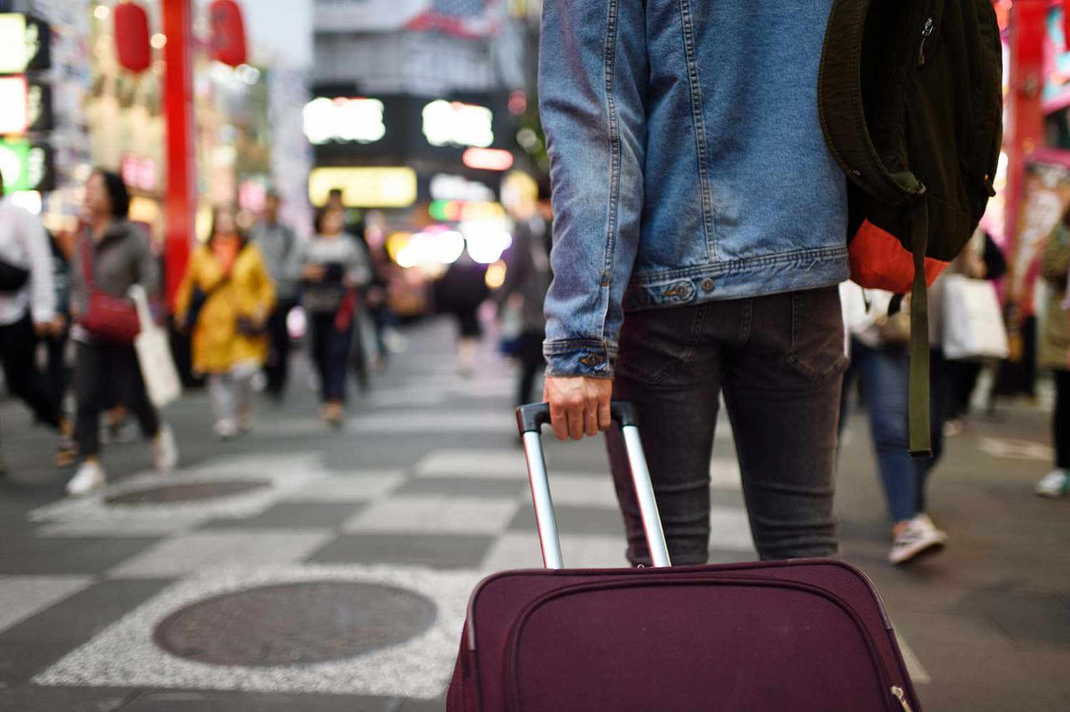 Traveling The World With A Stylish Purple Suitcase Wallpaper