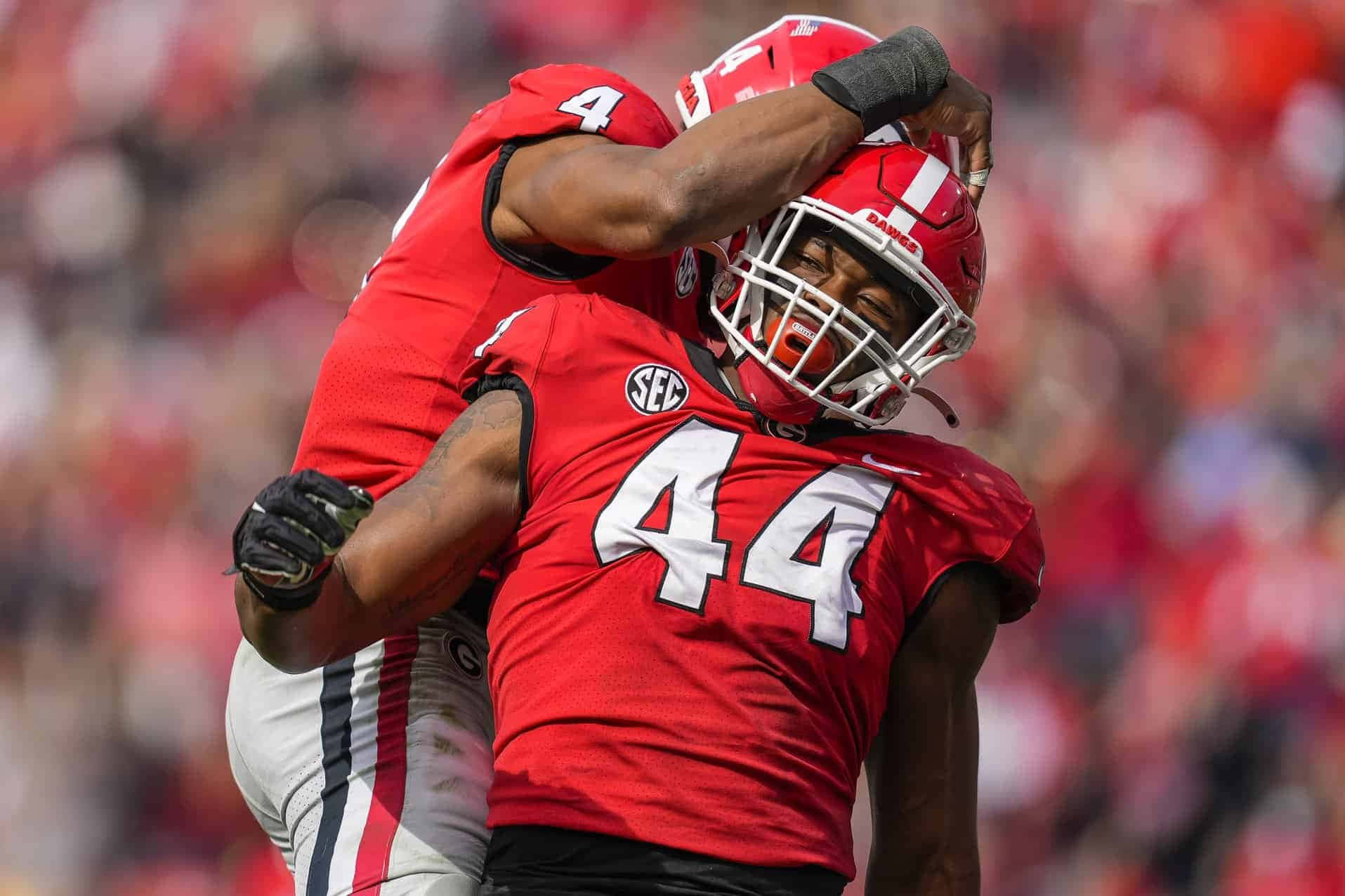 Travon Walker Gleefully Celebrating His Victory With A Teammate Wallpaper