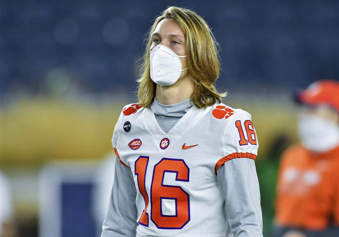 Trevor Lawrence Wearing Maskand Football Uniform Wallpaper