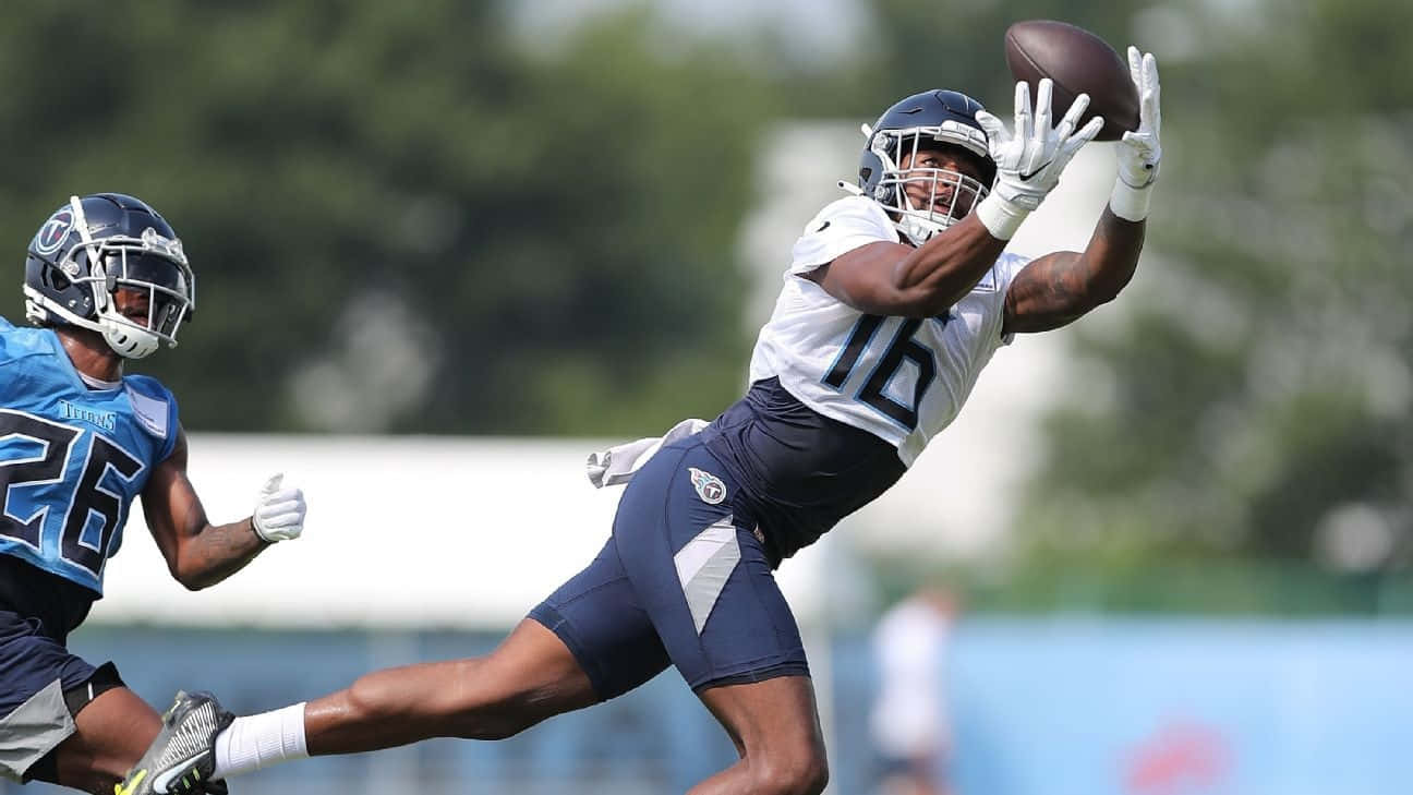 Treylon Burks Catching Football Practice Wallpaper