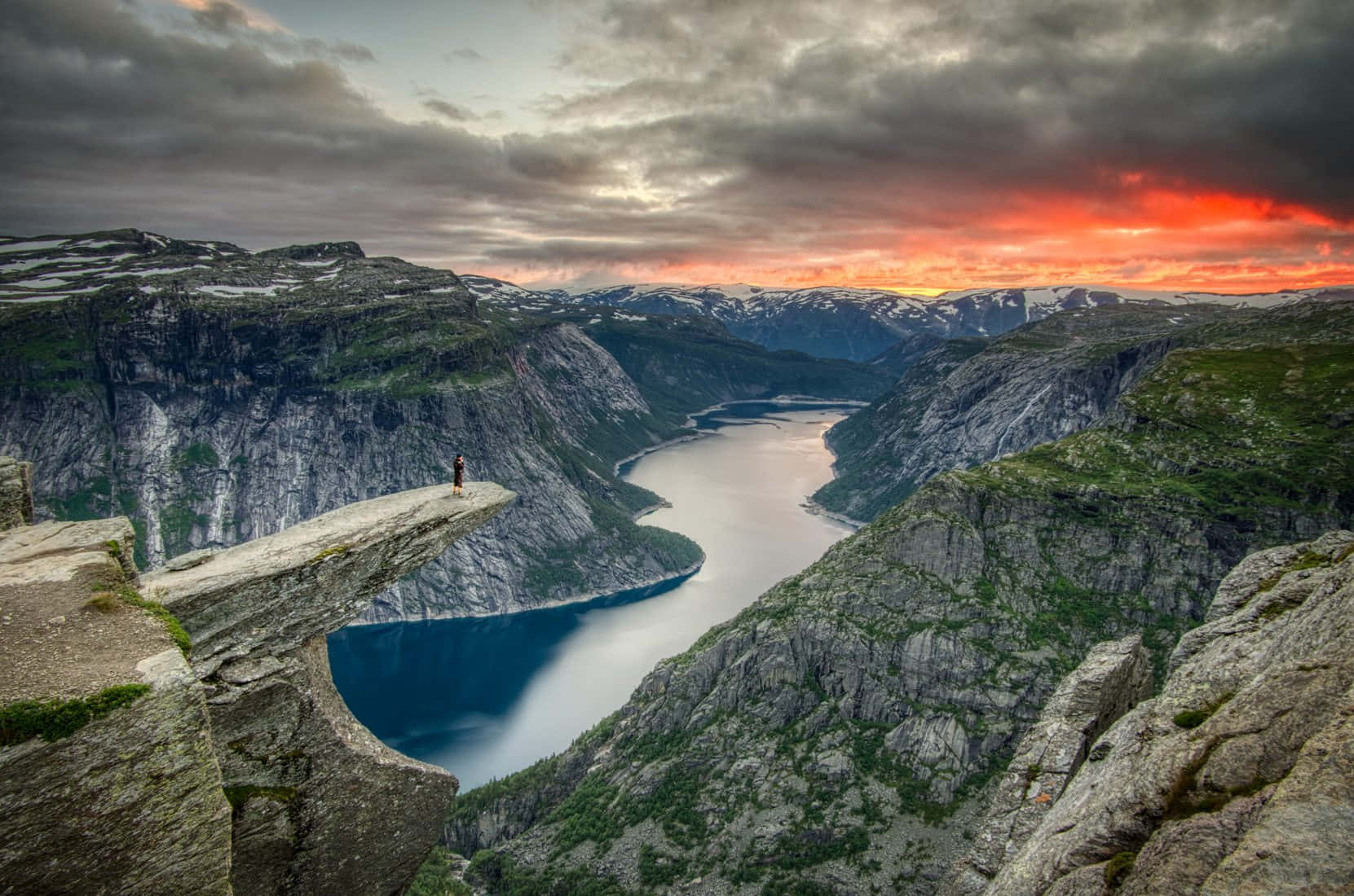 Trolltunga With Bright Orange Sunset Wallpaper