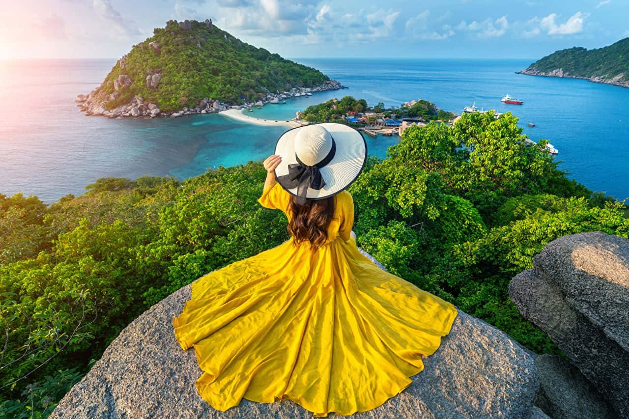 Tropical_ Island_ Viewpoint_with_ Woman_in_ Yellow_ Dress Wallpaper