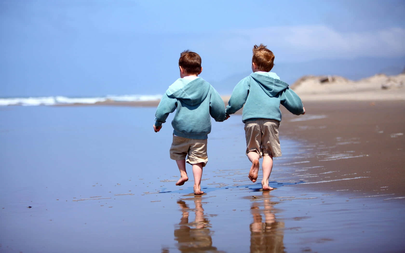 Two Adorable Kids Playing Outdoors Wallpaper