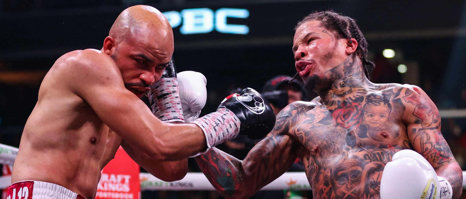 Two Boxers With Tattoos Fighting In A Boxing Ring Wallpaper