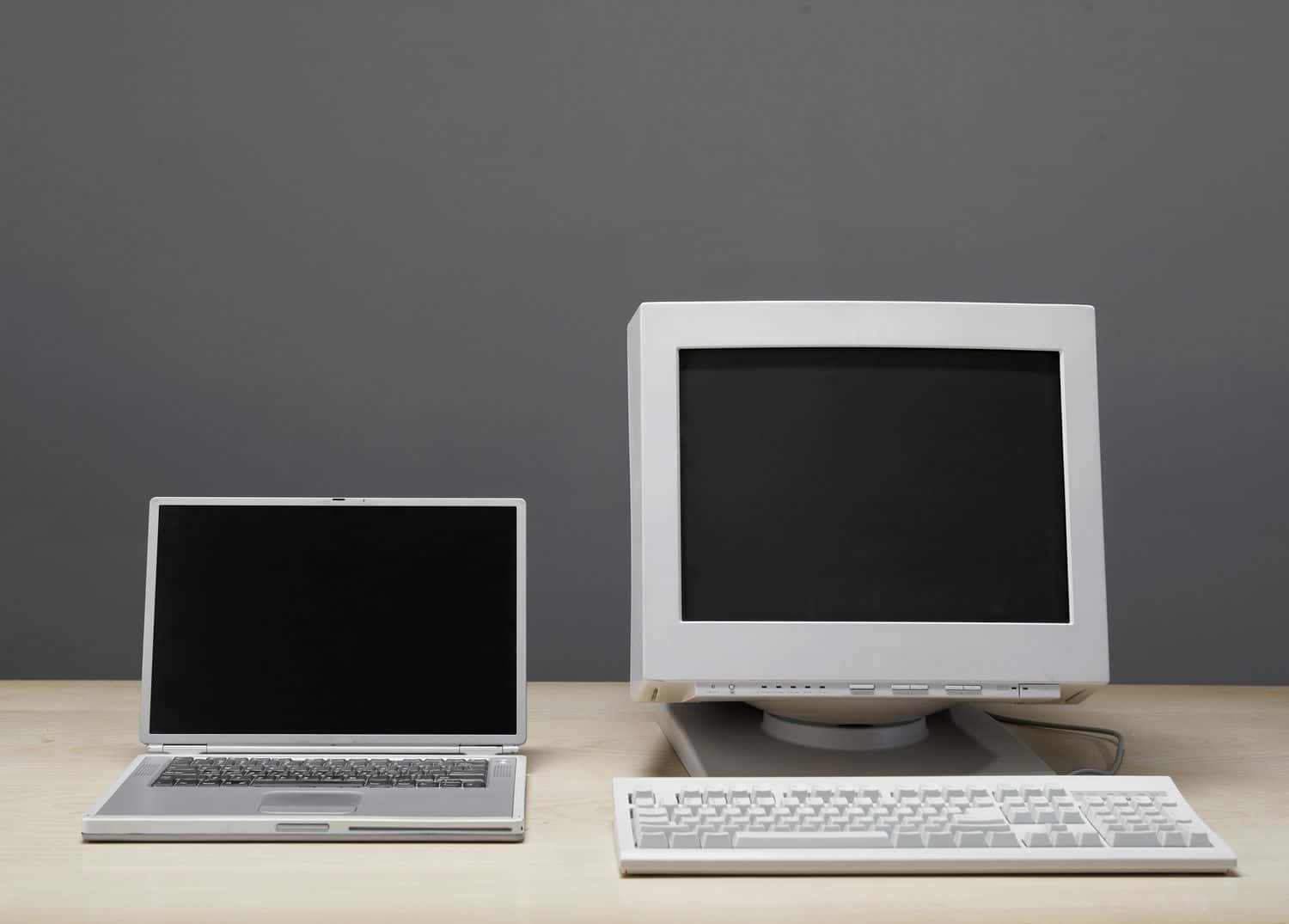 Two Computers On A Table With A Keyboard Wallpaper