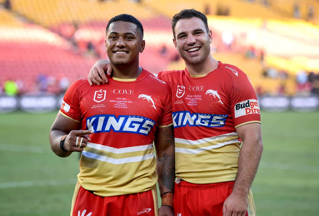 Two Rugby Players Standing Next To Each Other Wallpaper