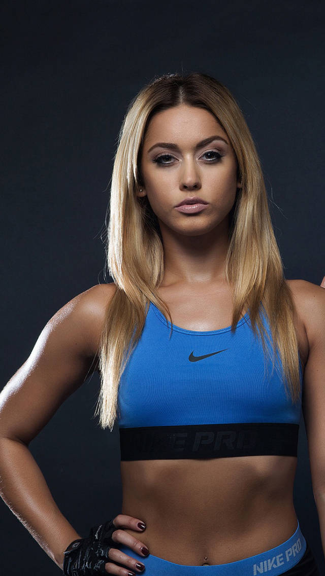 Two Women In Blue Sports Bras Posing For A Photo Wallpaper