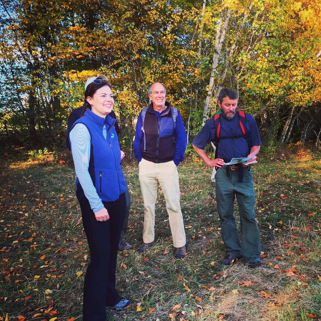 U.s. Senator Kelly Ayotte Stands In A Peaceful Forest Wallpaper