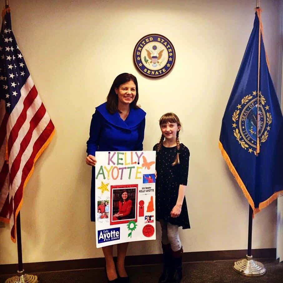 U.s. Senator Kelly Ayotte With A Little Girl Wallpaper