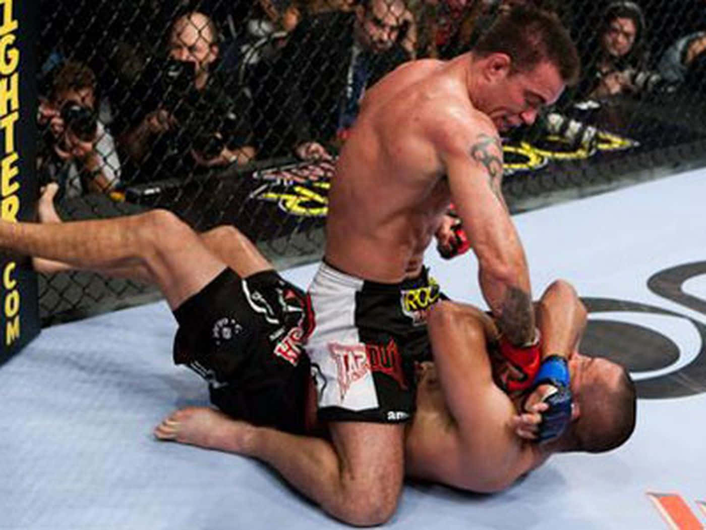 Ufc Athletes Jake Shields And Georges St-pierre In The Ring At Ufc 129 Wallpaper