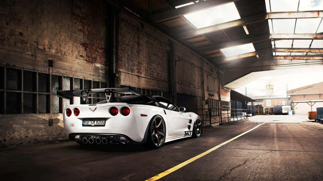 Unleash The Power: Exquisite Modified Car On The Road Wallpaper