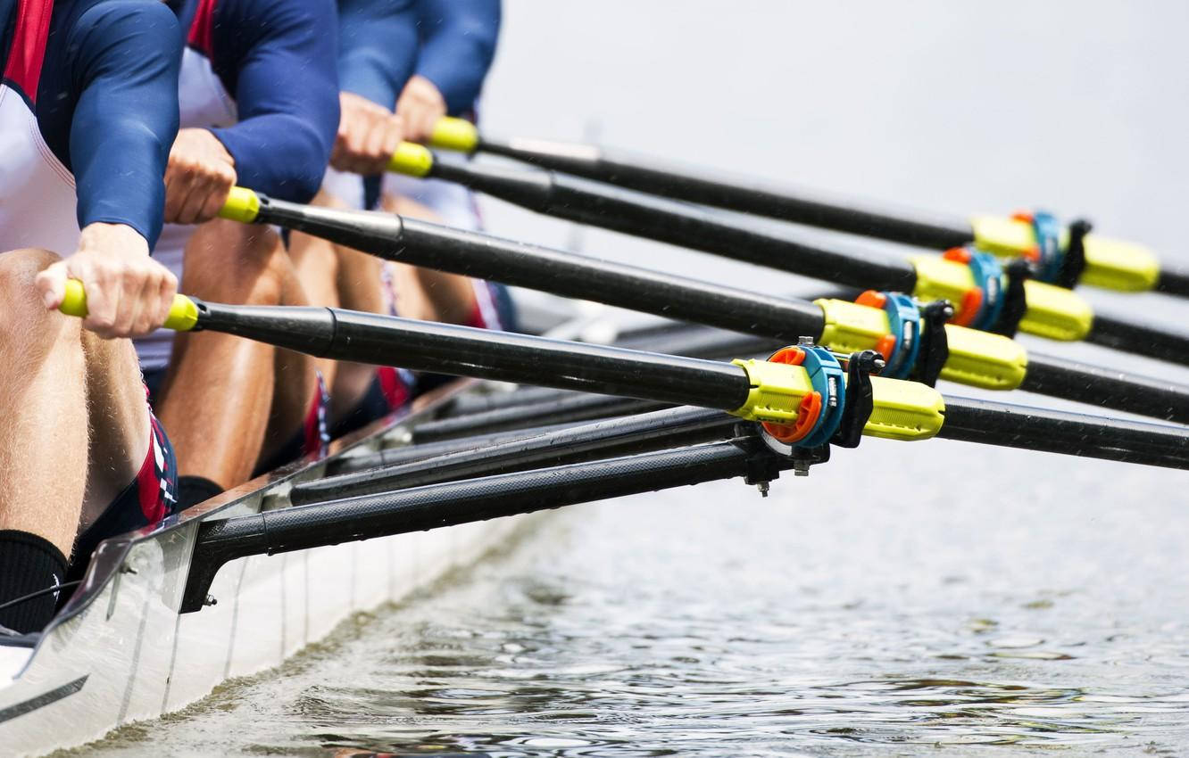 Unleashing Power And Grace On Water - A Close Up Of Rowing Oars Wallpaper