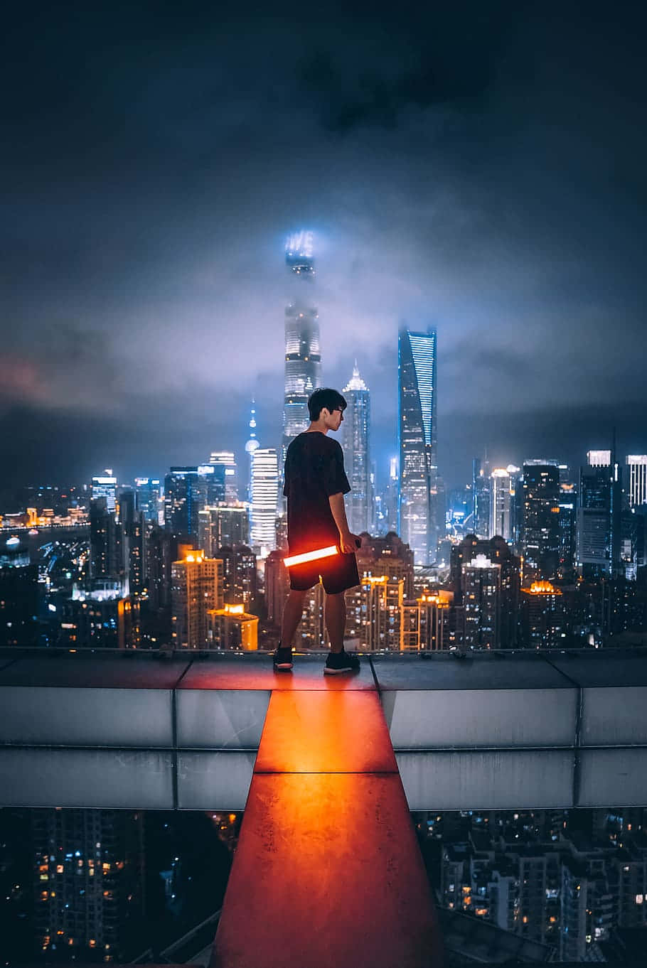 Urban Explorer Overlooking City Night Skyline Wallpaper