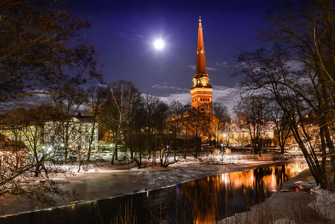 Vasteras Nighttime Churchand River Scene Wallpaper