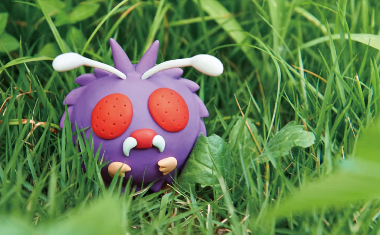 Venonat Toy On Grass Wallpaper