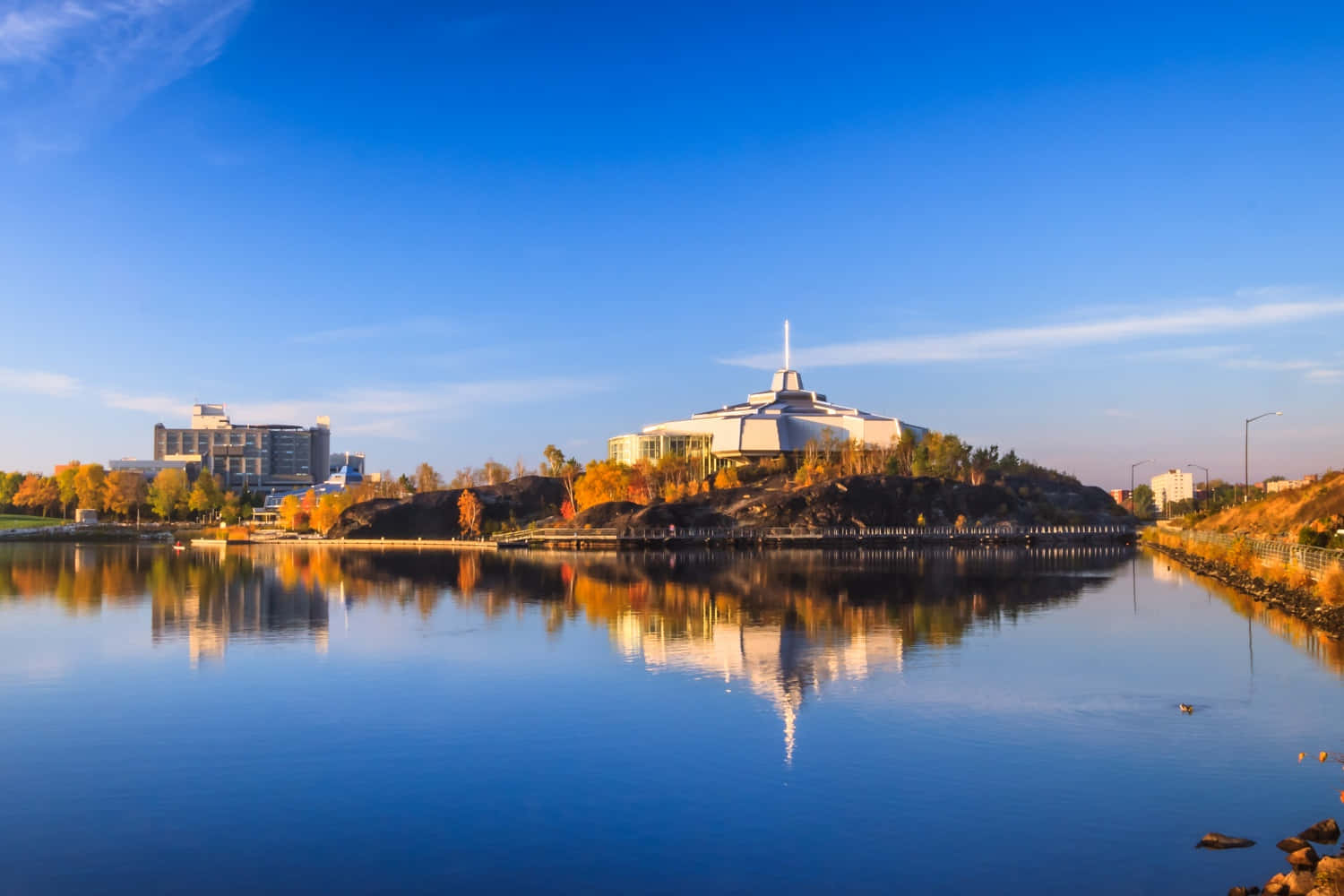 Vibrant Autumn Sunset Casting A Golden Glow Over The Pristine Ramsey Lake In Greater Sudbury Wallpaper