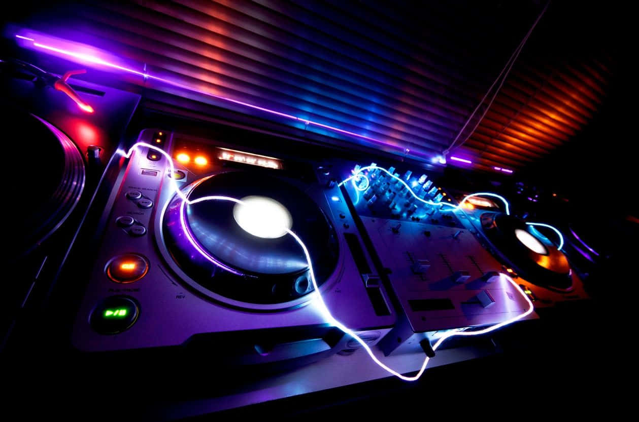 Vibrant D J Deck Under Club Lights Wallpaper