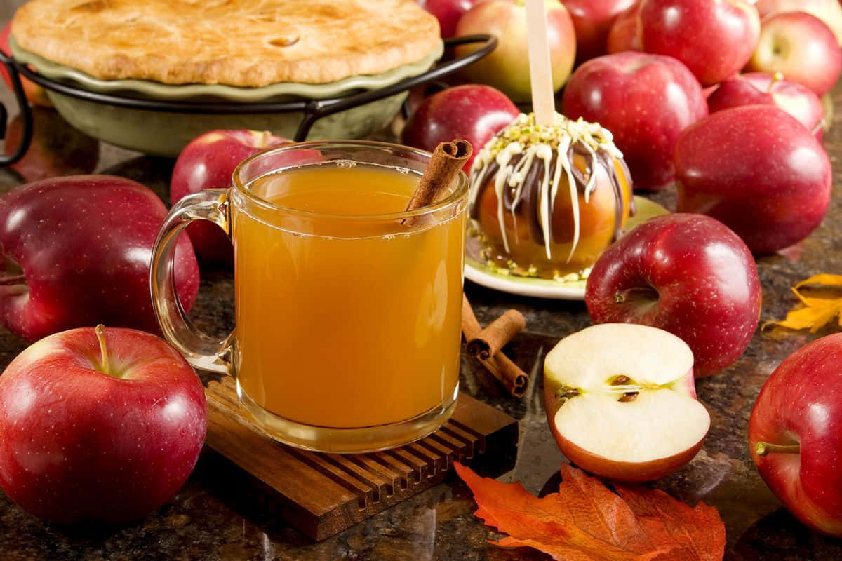 Vibrant Fall Apples On A Rustic Wooden Table Wallpaper