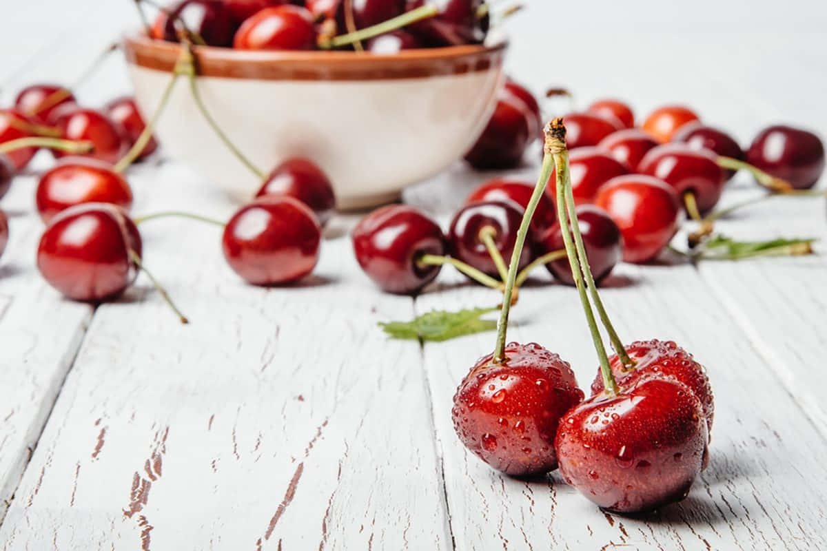 Vibrant Red Cherries On Display Wallpaper