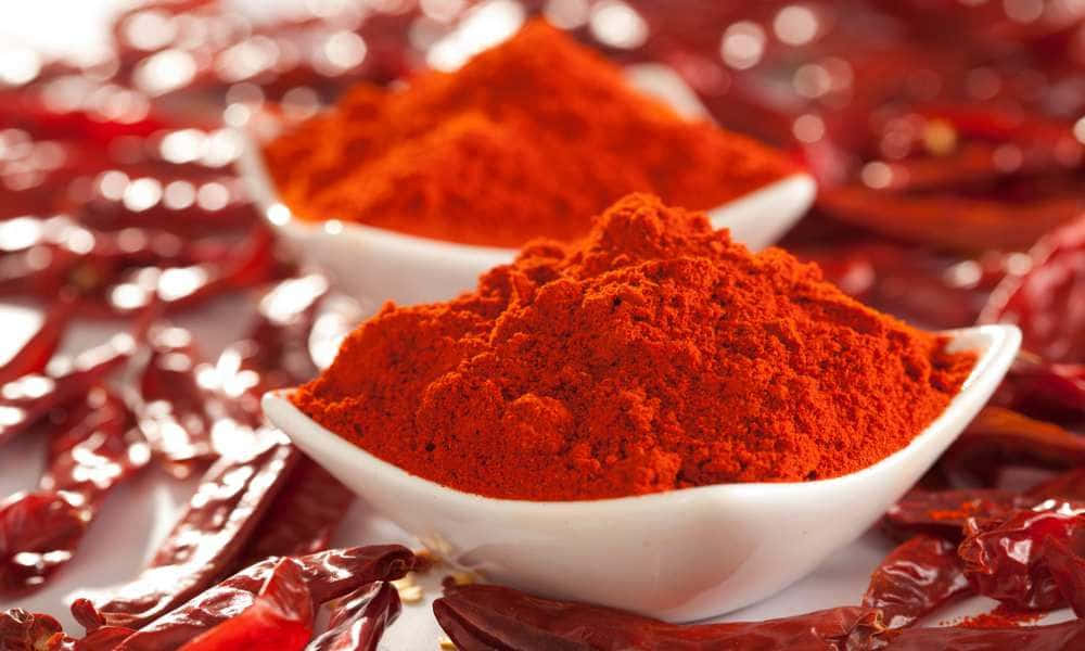 Vibrant Red Chili Powder In A Bowl Wallpaper